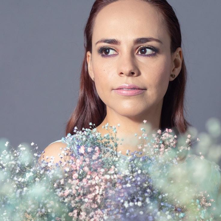 Kaveri Mehta, Lead Design Curator at UrbanPrismAlley, reviewing corporate floral arrangements